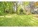 Expansive backyard features mature trees, lush greenery and well-kept lawn at 1763 Hearthstone Cir, Lawrenceville, GA 30043