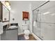 Modern bathroom features a sleek vanity, updated fixtures, and glass-enclosed shower stall at 1763 Hearthstone Cir, Lawrenceville, GA 30043