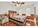 Charming bedroom with a queen bed, ceiling fan, and a classic bedside table with a lamp at 1763 Hearthstone Cir, Lawrenceville, GA 30043