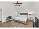 Bright bedroom featuring a queen bed, ceiling fan, and a conveniently placed desk and chair set at 1763 Hearthstone Cir, Lawrenceville, GA 30043