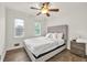 Cozy bedroom featuring a queen bed, ceiling fan, and natural light from two windows at 1763 Hearthstone Cir, Lawrenceville, GA 30043