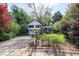 Charming two-story home featuring a stone facade, red door, two-car garage and a well-manicured lawn and mature trees at 1763 Hearthstone Cir, Lawrenceville, GA 30043