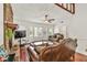 Bright living room featuring a stone fireplace, bay windows, and comfortable seating at 1763 Hearthstone Cir, Lawrenceville, GA 30043