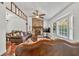 Inviting living room with stone fireplace, ceiling fan, hardwood floors, and large windows for natural light at 1763 Hearthstone Cir, Lawrenceville, GA 30043