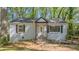 Inviting front of a bright home featuring an arched entryway, window shutters, and a tidy landscape at 2162 Doris Dr, Decatur, GA 30034