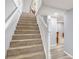 Carpeted staircase with white banister leading to the upper level of the home at 2162 Doris Dr, Decatur, GA 30034
