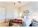 Cozy bedroom features neutral colors, a ceiling fan, and stylish decor at 2316 Hastings Manor Ln, Hampton, GA 30228