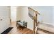 Welcoming foyer with hardwood floors, staircase and a bench at 2316 Hastings Manor Ln, Hampton, GA 30228