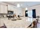 Bright kitchen boasts granite countertops, stainless steel appliances, and modern lighting at 2316 Hastings Manor Ln, Hampton, GA 30228