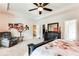 Bright main bedroom with a seating area, tray ceiling, and ample natural light at 2316 Hastings Manor Ln, Hampton, GA 30228