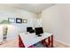 Functional office space with a desk, stylish lamp, and framed decor at 2316 Hastings Manor Ln, Hampton, GA 30228
