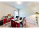 Well-lit office space with a large desk, red shelving and comfortable seating at 2316 Hastings Manor Ln, Hampton, GA 30228