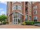 Elegant brick building entrance featuring modern architectural details and manicured landscaping at 325 E Paces Ferry Ne Rd # 312, Atlanta, GA 30305
