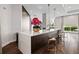 Sleek community kitchen island with quartz countertops, modern lighting, and bar seating at 325 E Paces Ferry Ne Rd # 312, Atlanta, GA 30305