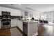 Contemporary kitchen with white cabinets, stainless steel appliances, and a view into the living area at 325 E Paces Ferry Ne Rd # 312, Atlanta, GA 30305