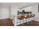 Modern kitchen with granite countertops, bar seating, stainless steel appliances, and hardwood floors at 325 E Paces Ferry Ne Rd # 312, Atlanta, GA 30305