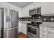 Modern kitchen with stainless steel appliances, granite countertops, and white cabinets at 325 E Paces Ferry Ne Rd # 312, Atlanta, GA 30305
