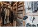 A walk-in closet features custom shelving and wooden poles for organizing clothes and shoes at 325 E Paces Ferry Ne Rd # 312, Atlanta, GA 30305