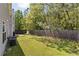 This is a backyard with a lawn, a wooden fence, and trees for privacy at 3571 Oakshire Se Way, Atlanta, GA 30354
