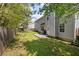 This is a backyard featuring a lawn, a wooden fence, and the exterior of the house at 3571 Oakshire Se Way, Atlanta, GA 30354