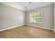 This is a view of the bedroom with hardwood floors, a window and neutral walls at 3571 Oakshire Se Way, Atlanta, GA 30354