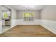 Dining room with hardwood floors, wainscoting and view into kitchen and living room at 3571 Oakshire Se Way, Atlanta, GA 30354