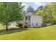 View of home, featuring manicured lawn and mature trees at 3571 Oakshire Se Way, Atlanta, GA 30354