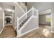 Elegant foyer with hardwood floors, white staircase, and open layout at 3571 Oakshire Se Way, Atlanta, GA 30354
