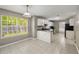 Bright eat-in kitchen features white cabinets and modern appliances with views to the backyard at 3571 Oakshire Se Way, Atlanta, GA 30354