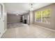 Open concept living area with a fireplace and large windows with a view to the backyard at 3571 Oakshire Se Way, Atlanta, GA 30354