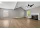 Spacious living room featuring a fireplace, ceiling fan, and hardwood floors at 3571 Oakshire Se Way, Atlanta, GA 30354