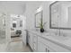 Bright bathroom features dual sinks, a glass shower and tile flooring at 392 Pratt Dr # 2013, Atlanta, GA 30315