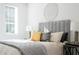 Well-lit bedroom features a padded headboard and large window for natural light at 392 Pratt Dr # 2013, Atlanta, GA 30315