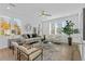 Bright living room with a ceiling fan, neutral-toned furniture, large windows, and contemporary decor at 392 Pratt Dr # 2013, Atlanta, GA 30315