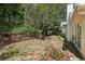 Secluded backyard space with mature trees and a wooden retaining wall at 4805 Diggers Way, Sugar Hill, GA 30518