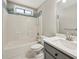 Updated bathroom with a shower and tub combination with mosaic tile and a modern gray vanity at 4805 Diggers Way, Sugar Hill, GA 30518