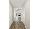 Long hallway with wood floors leading to a living area with a fireplace and vaulted ceilings at 4805 Diggers Way, Sugar Hill, GA 30518