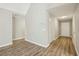Light-filled hallway with wood-look floors, leading to a white front door and closet at 4805 Diggers Way, Sugar Hill, GA 30518