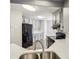 Kitchen view features an open layout with grey cabinetry and stainless steel appliances at 4805 Diggers Way, Sugar Hill, GA 30518