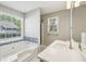 Main bathroom featuring a soaking tub, walk-in shower, and dual-sink vanity at 4805 Diggers Way, Sugar Hill, GA 30518