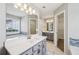 Bright main bathroom showcasing dual sinks, a soaking tub, and a large mirror at 4805 Diggers Way, Sugar Hill, GA 30518