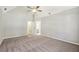 Spacious main bedroom with high vaulted ceilings, neutral paint, and carpet at 4805 Diggers Way, Sugar Hill, GA 30518