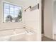 Bathroom showcasing a large tub, tile surround, and separate shower at 772 Bostonian Way, Lawrenceville, GA 30046
