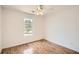 This bedroom features hardwood floors, a ceiling fan, and a window with a view at 772 Bostonian Way, Lawrenceville, GA 30046