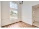 Bright dining area features hardwood floors, tall windows, and views of the entryway at 772 Bostonian Way, Lawrenceville, GA 30046