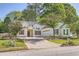 Traditional one-story home with attached garage and driveway and manicured front lawn with trees at 772 Bostonian Way, Lawrenceville, GA 30046