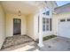 The front entrance has stone flooring and classic column, next to attached garage door at 772 Bostonian Way, Lawrenceville, GA 30046