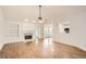 Open-concept living room with hardwood floors, fireplace, built-in shelves, and plenty of natural light at 772 Bostonian Way, Lawrenceville, GA 30046