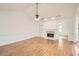 Neutral living room with hardwood floors, a fireplace, and a large ceiling fan at 772 Bostonian Way, Lawrenceville, GA 30046