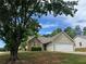 Charming single-Gathering home with stone accents, a well-maintained lawn, and an attached two-car garage at 10111 Commons Way, Jonesboro, GA 30238